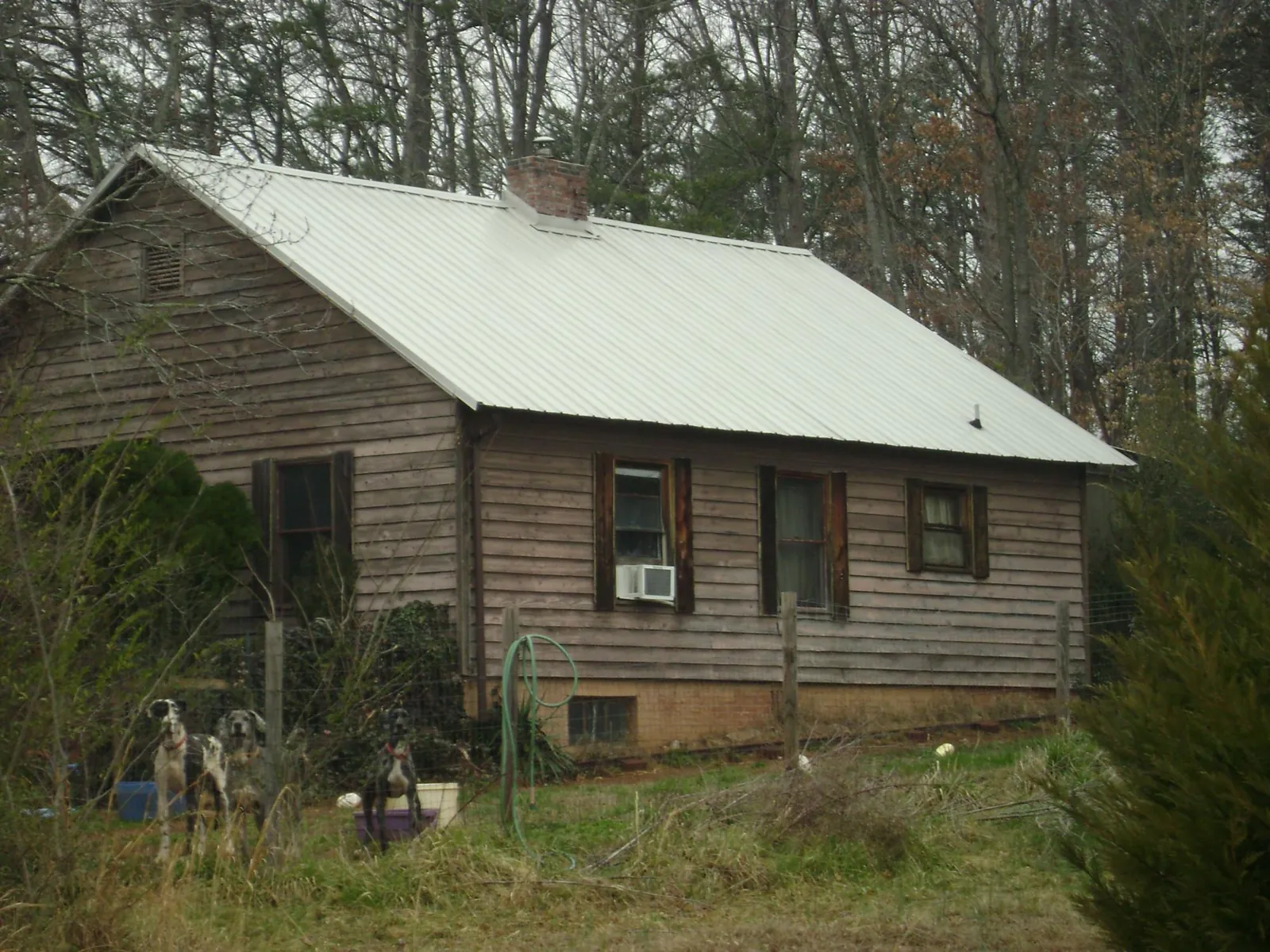 White metal roof on an old wood sided farmhouse, from a Metal Roof Installation job in Pepperell